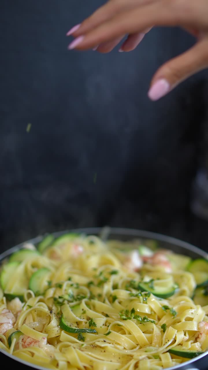 Cooking delicious pasta with shrimp and zucchini