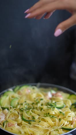 cooking delicious pasta with shrimp and zucchini