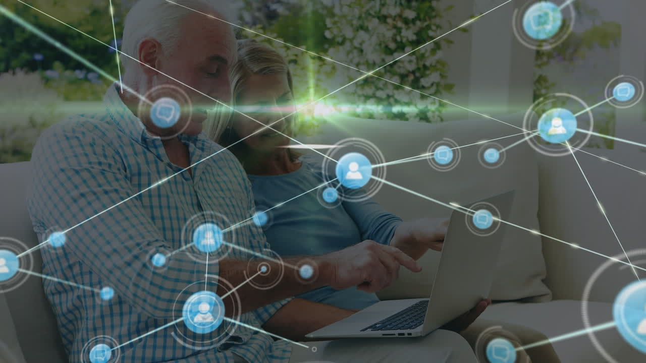animación de la red de conexiones con iconos sobre pareja caucásica usando portátil
