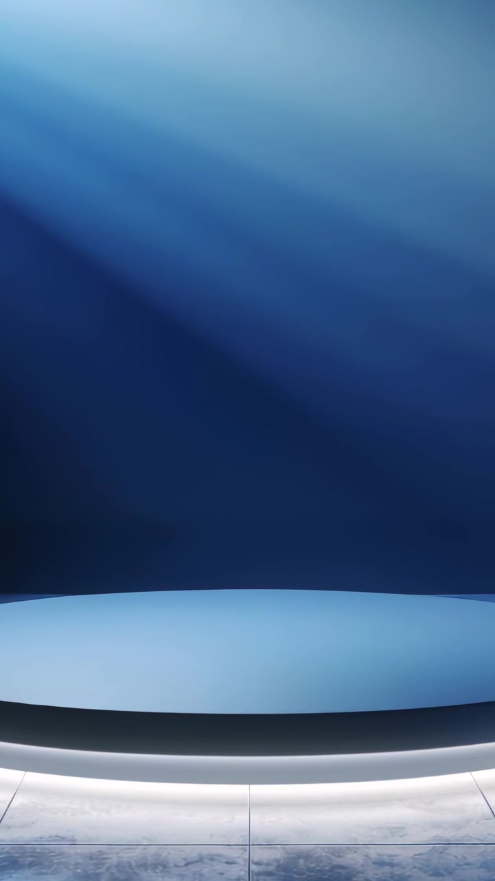 Video verticale: Luci dinamiche creano un luccichio su anello LED e parete blu su un palco da studio.