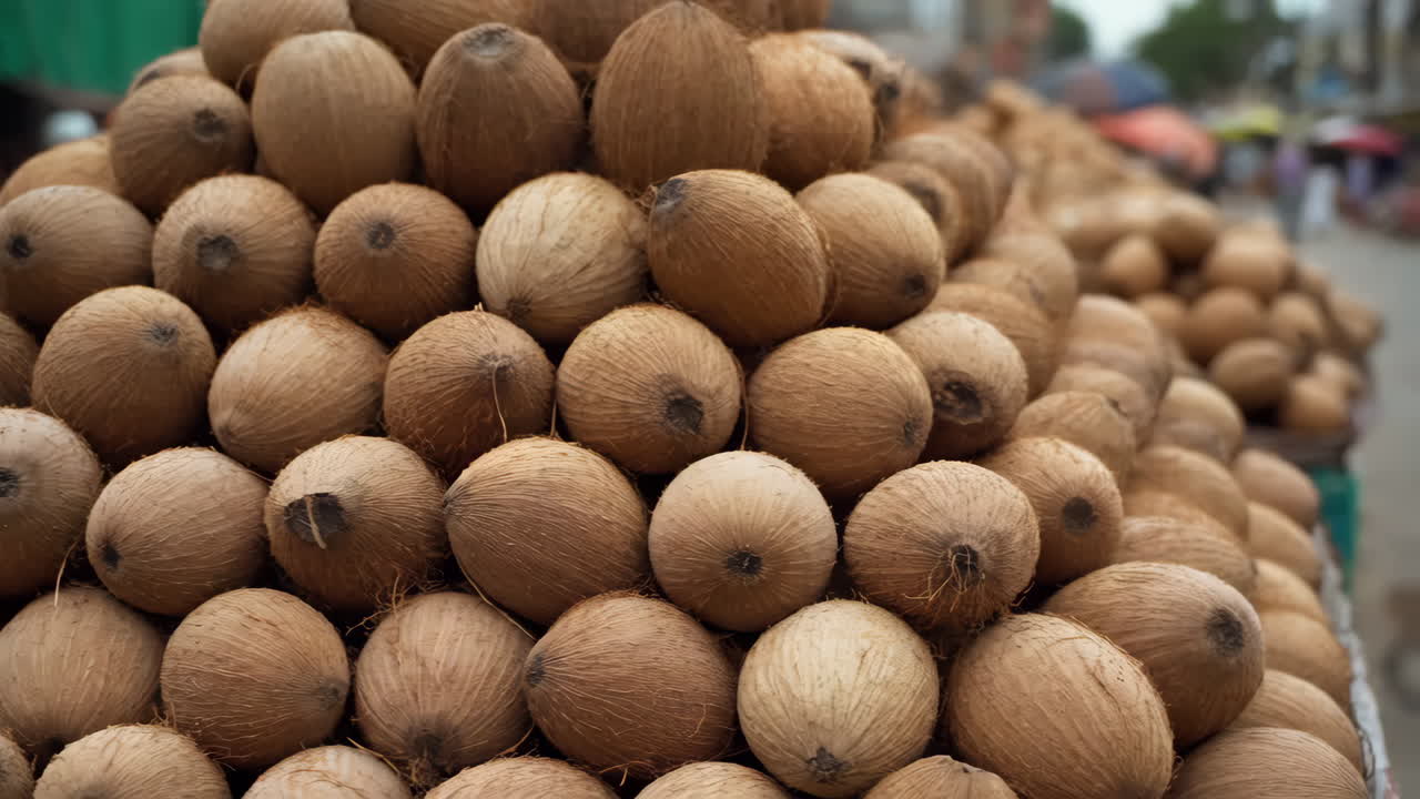 A large stack of coconuts at a market