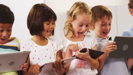 children-laughing-and-using-tablet-computer-
