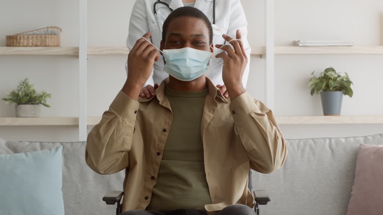 Doctor assisting patient with mask