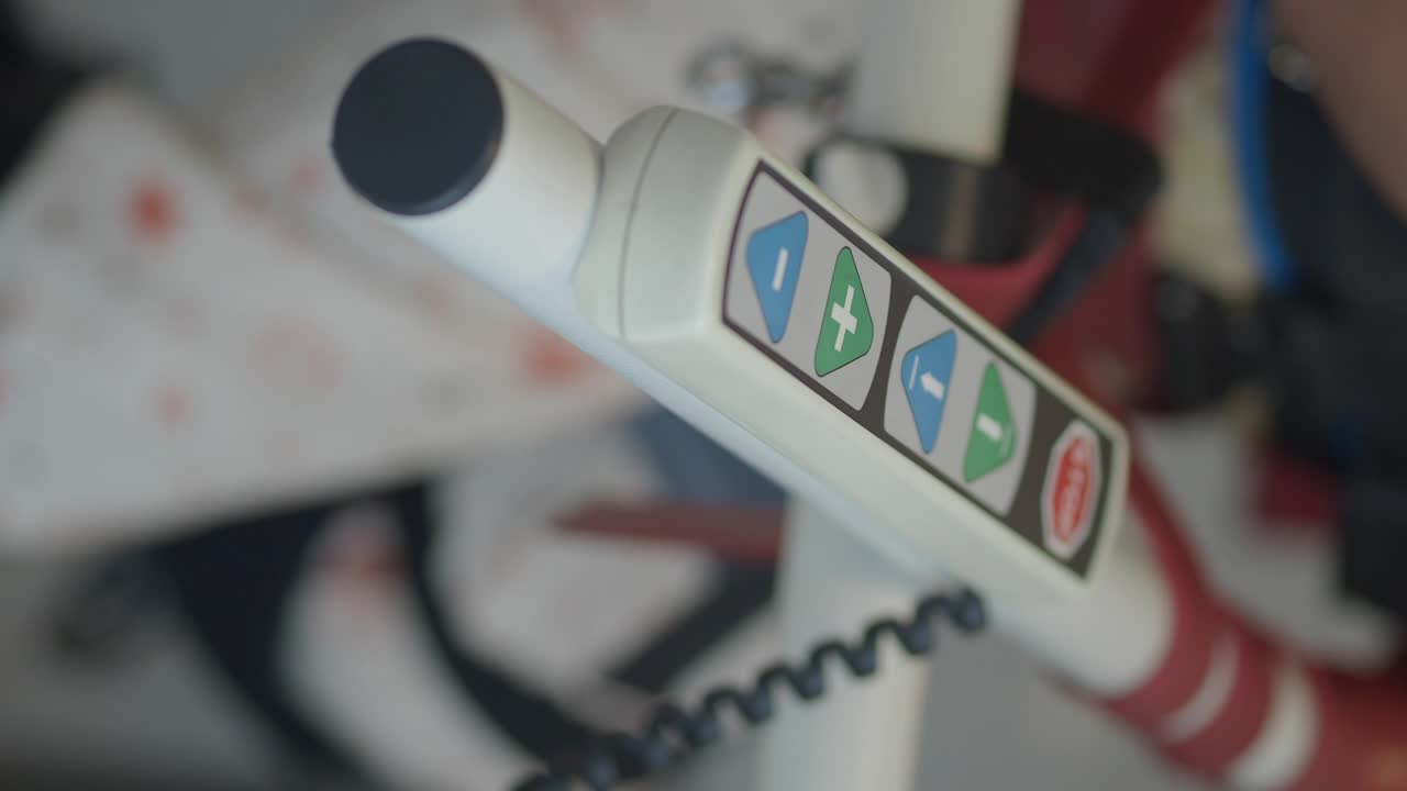 Close-up of a control panel on a medical or exercise device with adjustment buttons