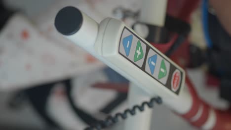 close-up of a control panel on a medical or exercise device with adjustment buttons