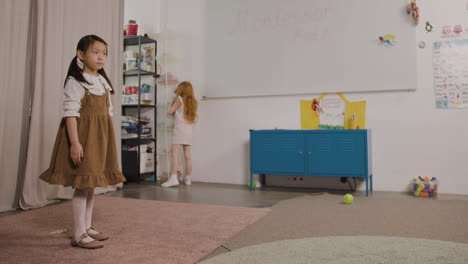 Little-Girl-Spinning-In-Classroom-In-A-Montessori-School