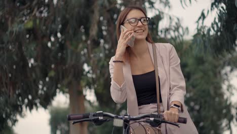 woman on a bike talking on the phone