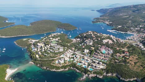 syvota islands, hotels, boats and beaches in ionian sea, epirus, greece mainland - aerial pan left