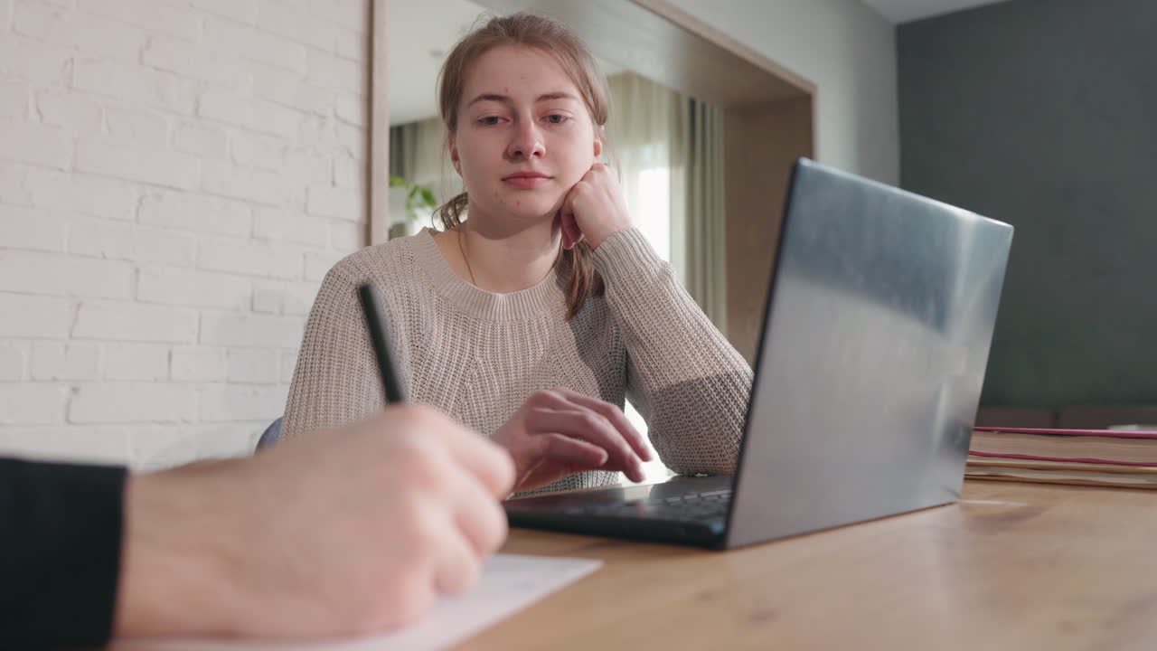 Young woman studying online with tutor