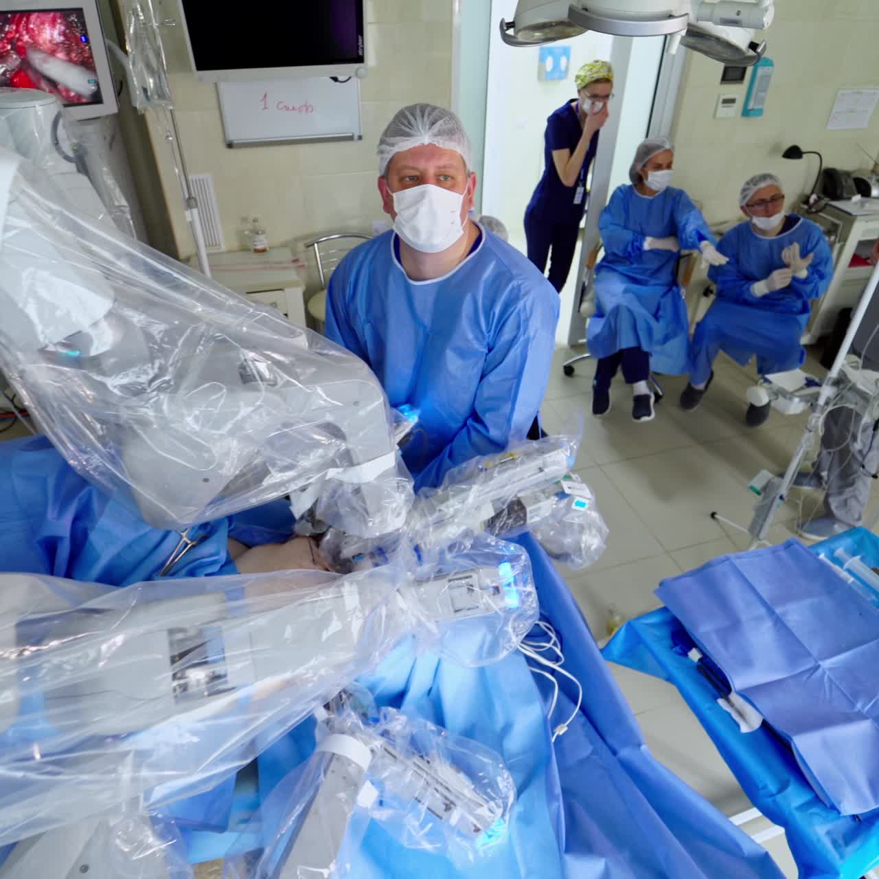 Modern medicine. Surgeon team uses medical robotic system for human treatment operation in hospital. Innovative operating room