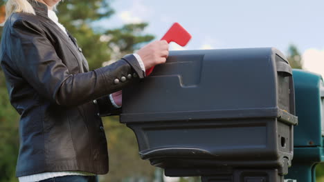 Woman-Places-Post-in-Mail-Box