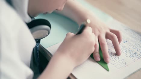 close up schoolboy doing homework