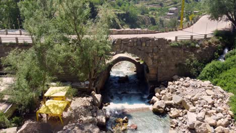 stream flowing from the mountains in afqa lebanon - aerial shot