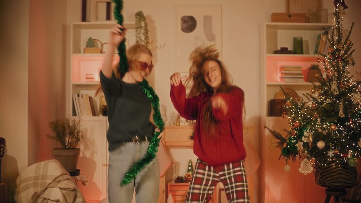 Female friends enjoys dancing together at home