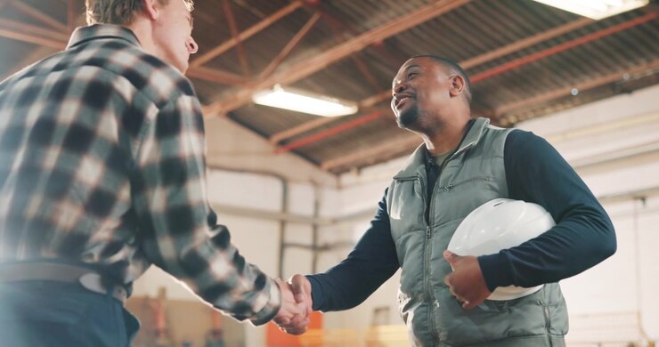 Two Men Shaking Hands in a Warehouse