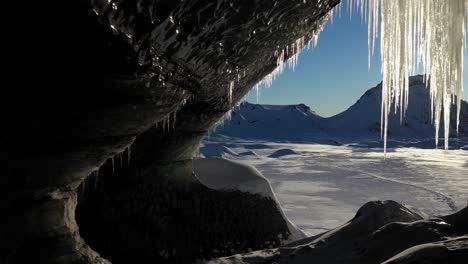 inside looking out of the entrance of an ice-cave in myrdalsjokull glacier in south iceland