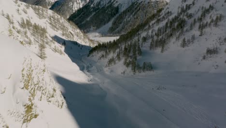 amazing ski run through austrian alps mountain valley, winter aerial view