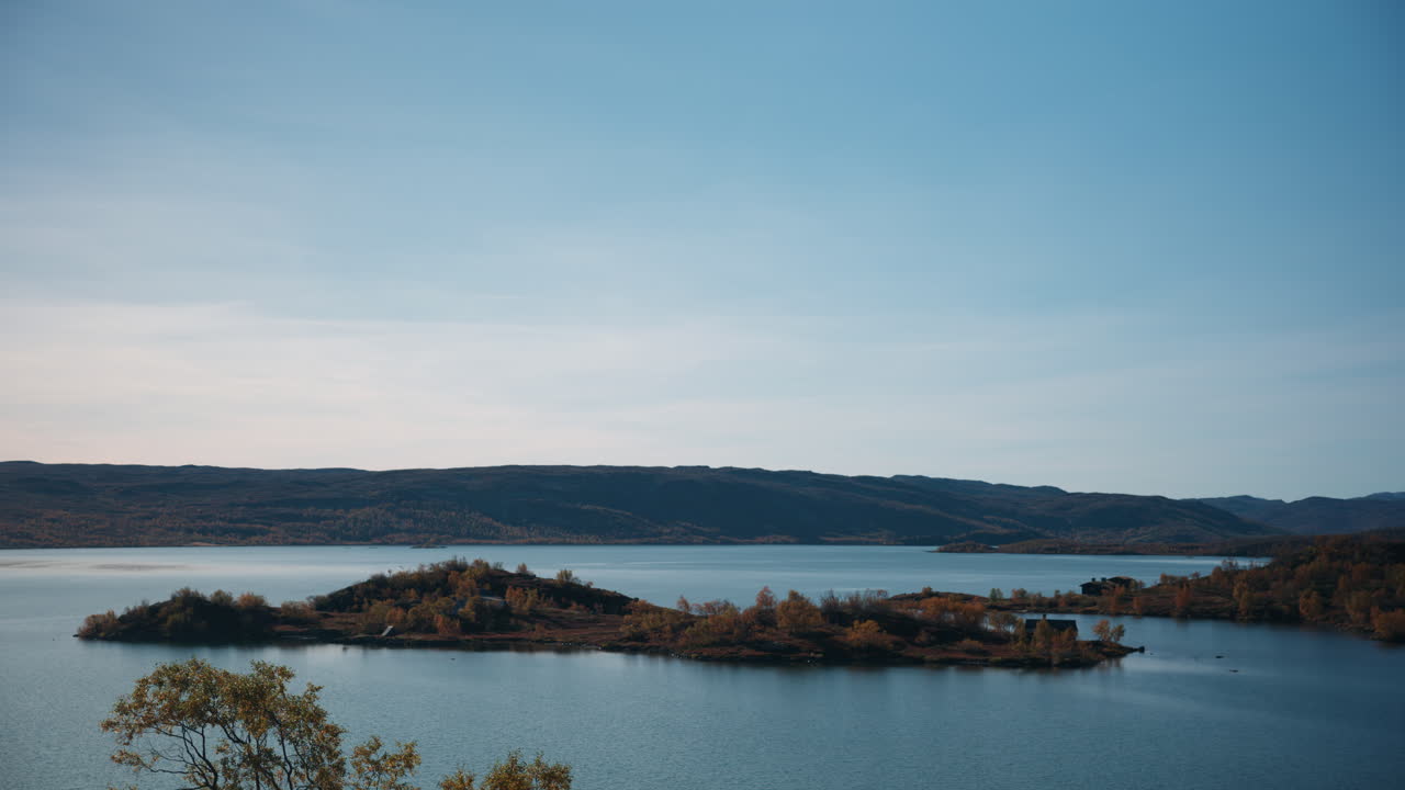 Scenic landscape shot of an island in a lake up in the mountains in Norway