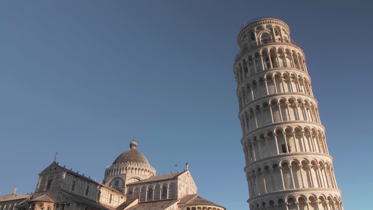 foto fija con un pájaro cruzando a la derecha frente a la torre inclinada de pisa en toscana italia durante la mañana y la hora dorada