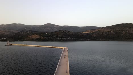 famous bosset bridge connection argostoli city bay in greece, aerial forward