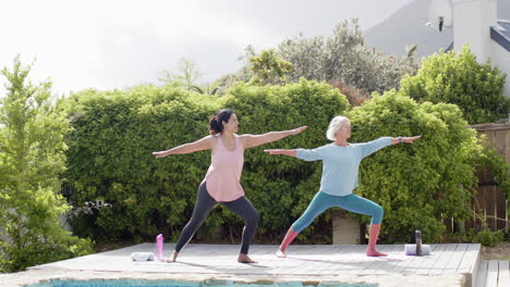 two happy diverse senior women exercising and spending time in home, slow motion