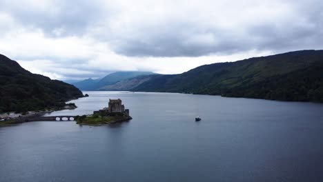 eilean donan castle on loch long near dornie, west coast of scotland, scottish highlands - aerial drone 4k hd footage fly out