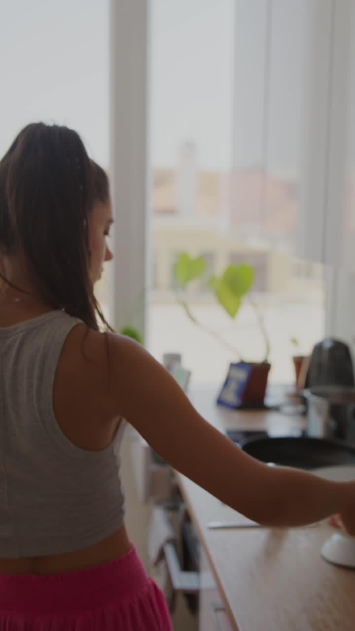 A young woman in a kitchen setting