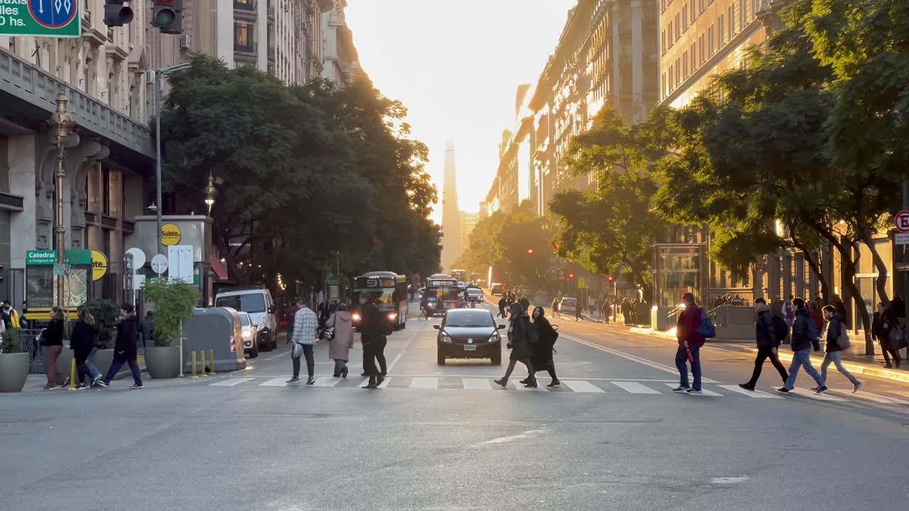 Pedestrians and Traffic on a Busy City Street at Golden Hour