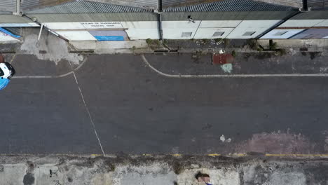 aerial footage top down view of a kartcross coming out of a garage making a curve at high speed drifting