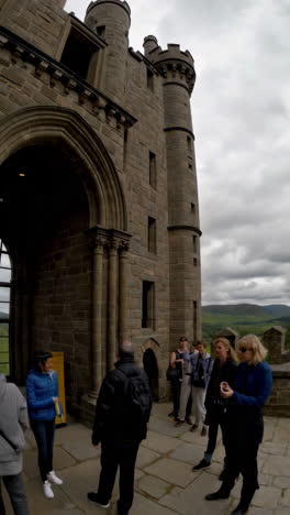 exterior view of a historic castle with tourists