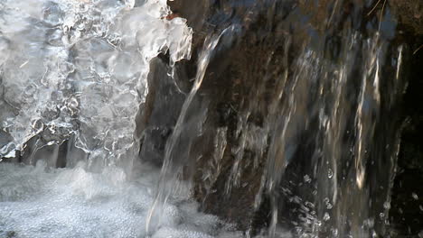 close up running water and ice in a stream 2