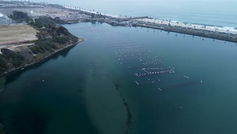 slow pan up carlsbad lagoon and oyster farm, drone view