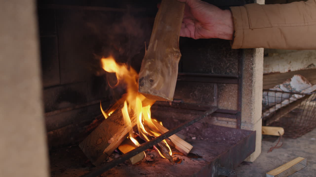 Unrecognizable Person Kindling Fire in Fireplace