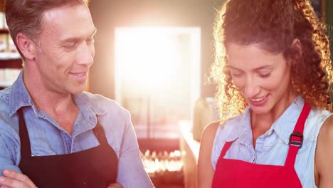 Smiling-staff-interacting-at-bakery-counter