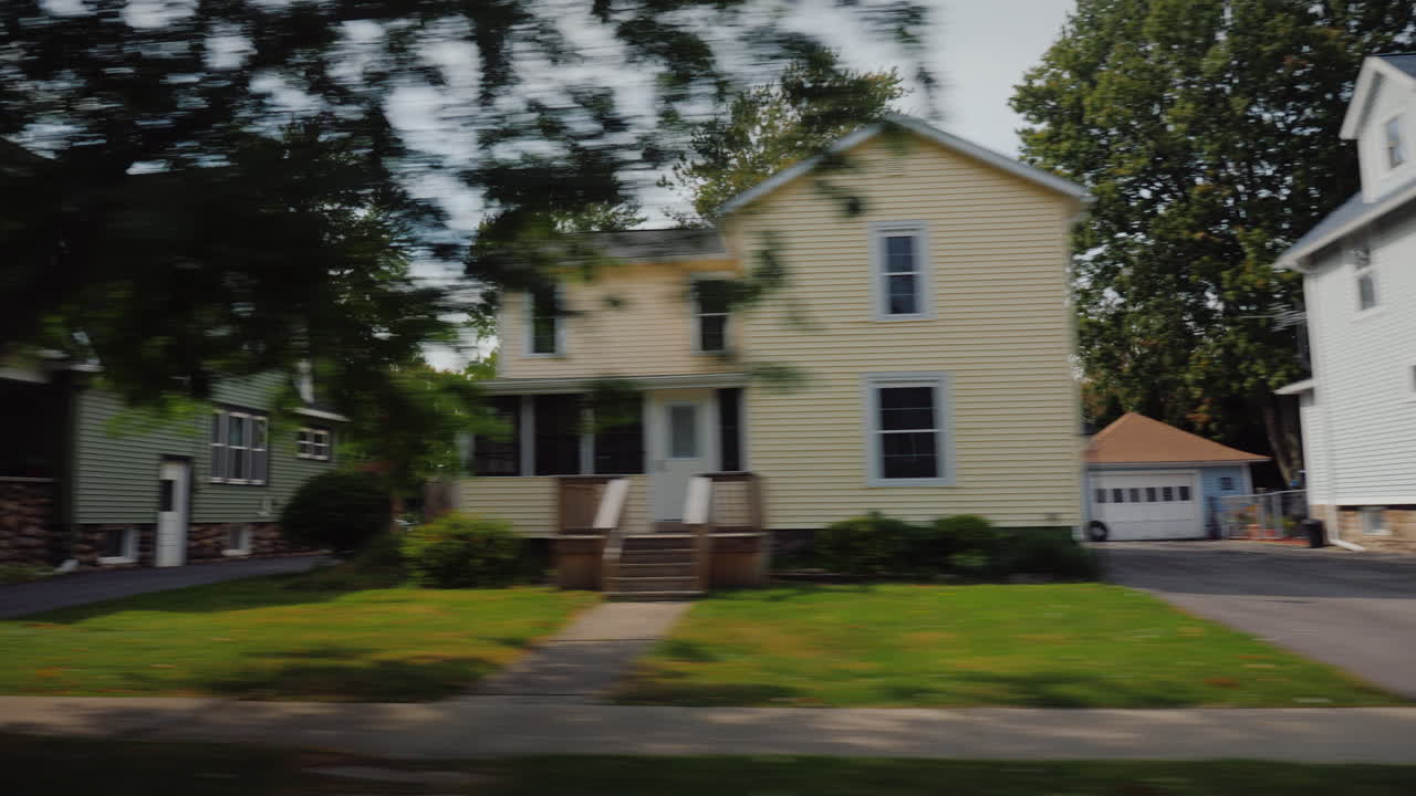 Ride Along Typical American Suburbs View From The Window Of The Car - Visible White Wooden Houses An
