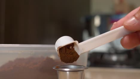 Extreme-closeup-shot-loading-Reusable-Coffee-capsule-with-coffee-powder-in-Slow-motion