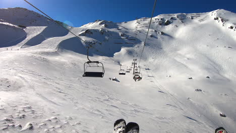 a ride in the ski lift over ski slopes in the zillertal with blue sky