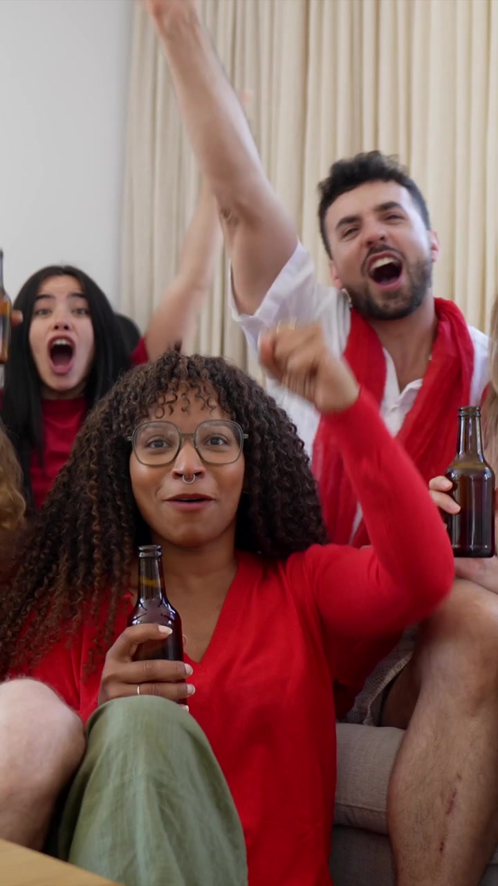 Excited Friends Cheering and Celebrating While Watching a Game at Home