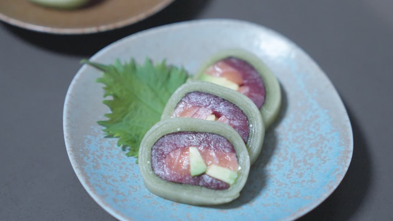 A rising rack-focused shot overlooking a variety of sushi rolls, showcasing fresh sushi types. Perfect for highlighting sushi assortments, Japanese cuisine, and food presentation.