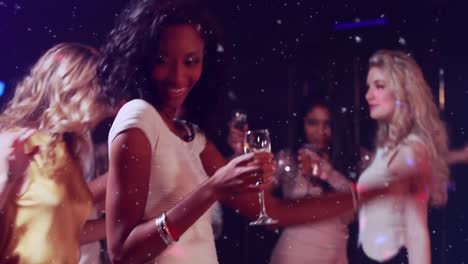 Animation-of-white-specks-over-happy-woman-dancing-having-fun-at-party