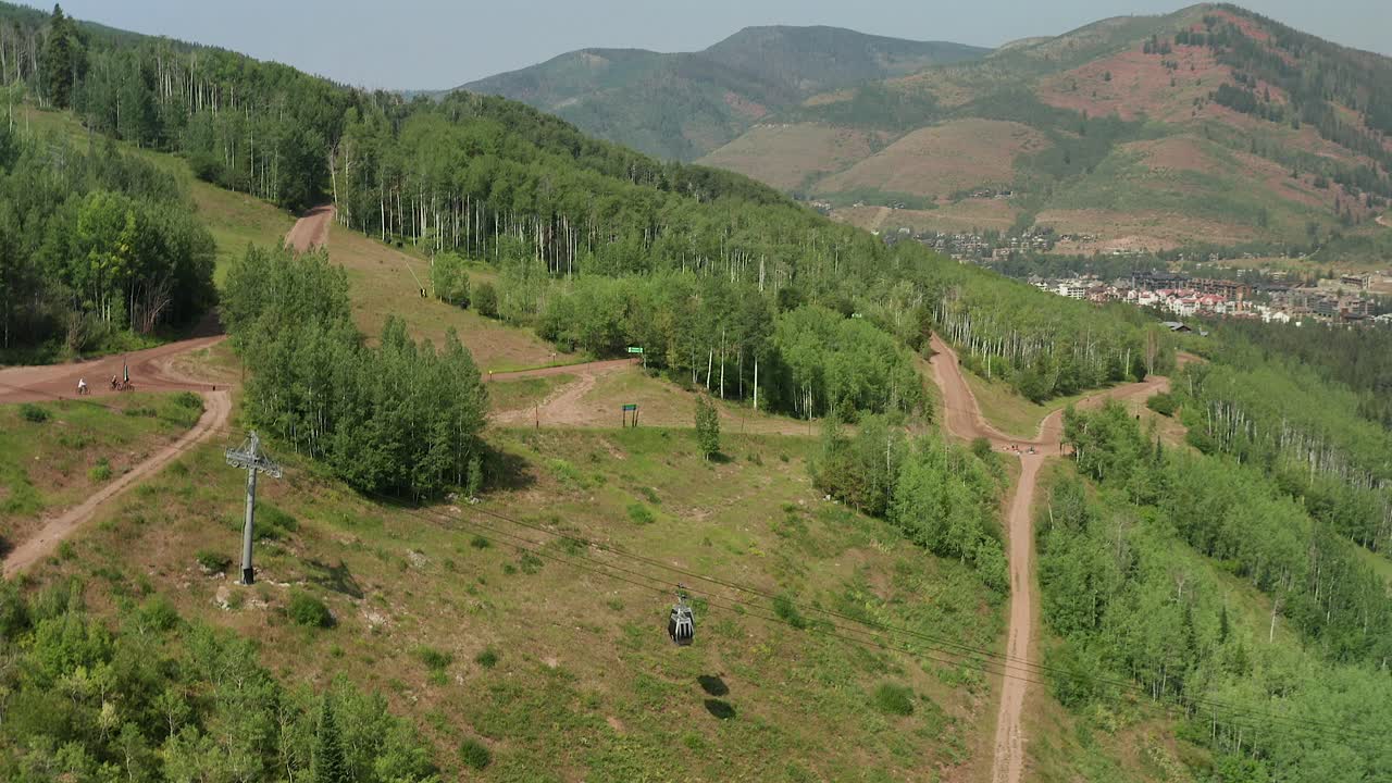 imágenes aéreas sobre las góndolas en vail colorado, mientras el ciclista de montaña baja la montaña