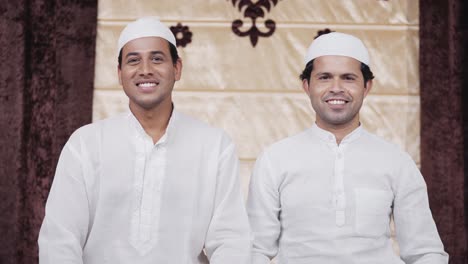 happy indian muslim men smiling at the camera