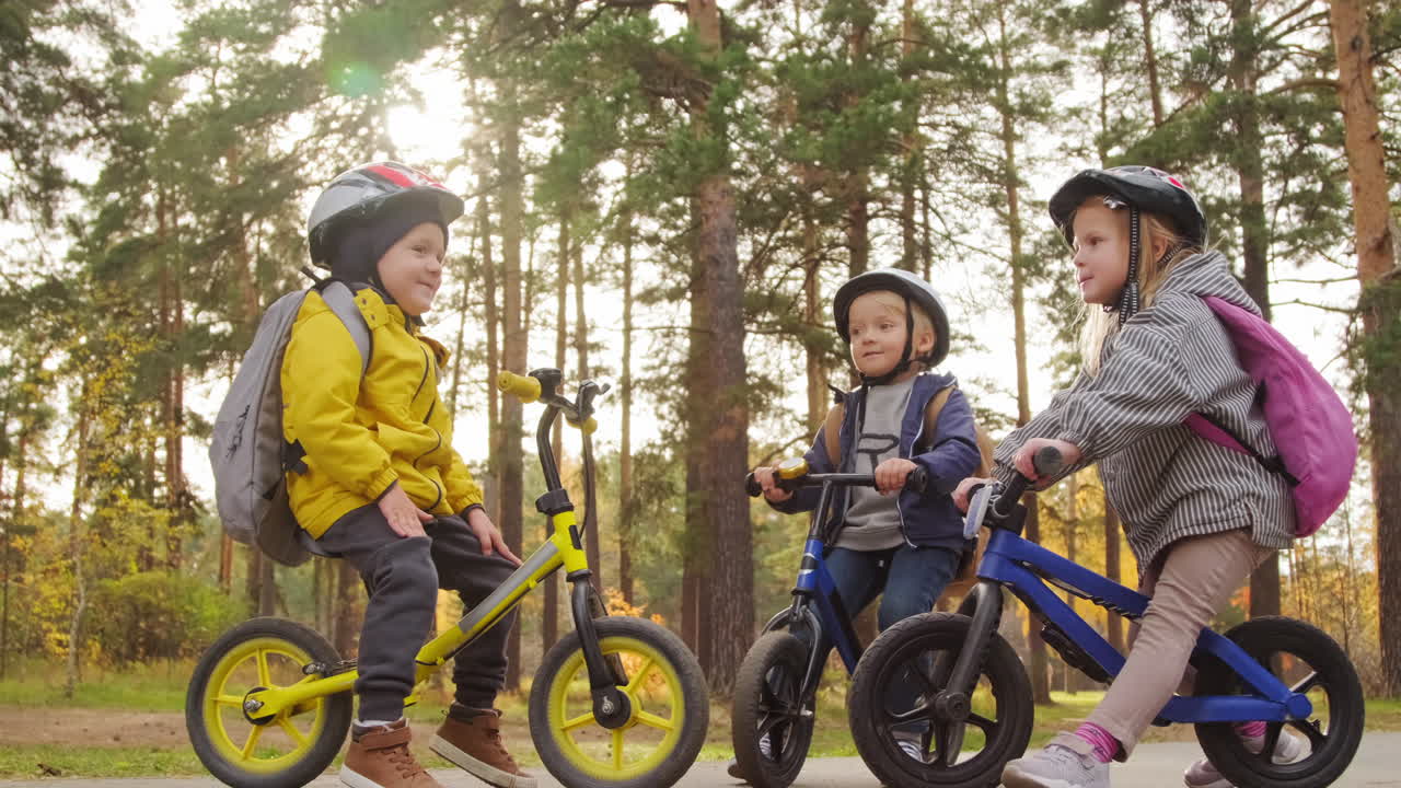 Cute Little Children on Balance Bicycles in Park