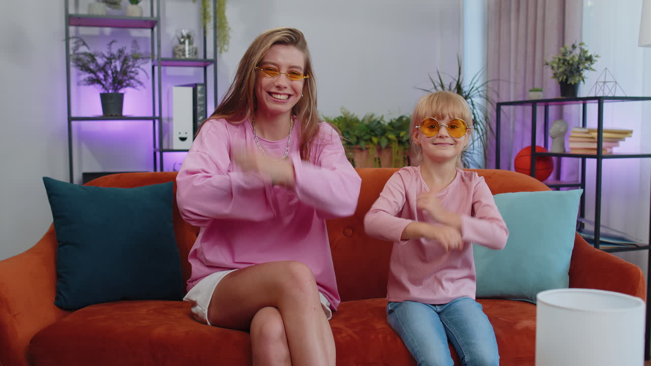 블로거 어머니와 아이 아이 딸이 음악을 듣고, 춤을 추고, 소셜 미디어 콘텐츠를 녹음합니다.