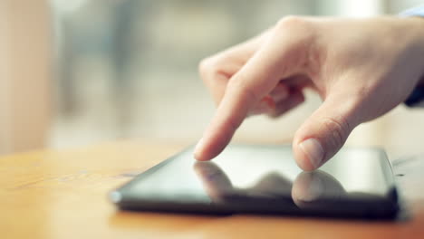 finger touching touchscreen tablet computer closeup browsing