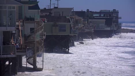 large waves crash along a southern california beach near malibu endangering houses and residents 2