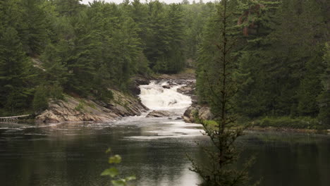 Agua-Cayendo-En-Cascada-Por-Una-Cascada-En-Un-Lago-Tranquilo