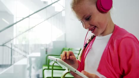 Girl-listening-to-music-from-digital-tablet