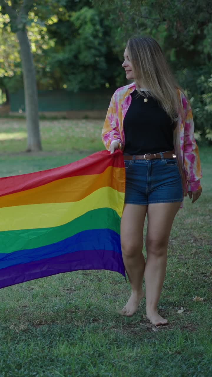 People holding a pride flag in a park