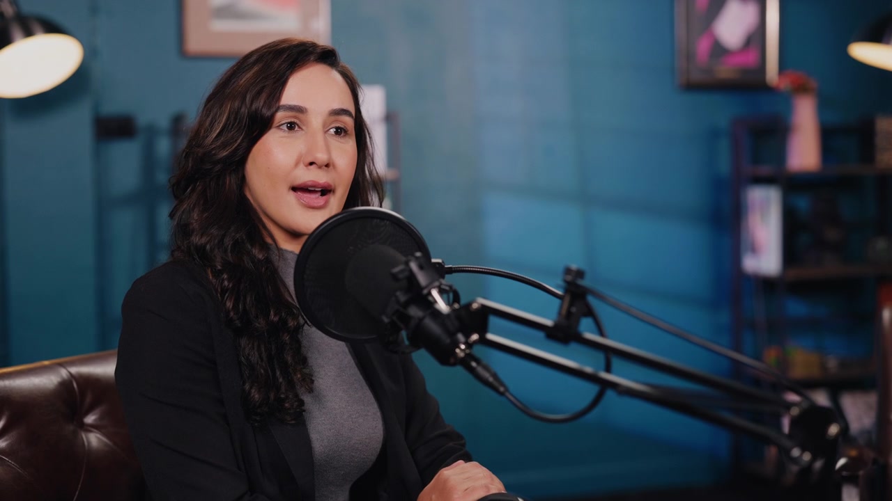 Young Woman Speaking into Microphone During Podcast Recording
